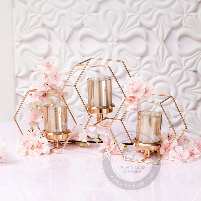 MELI gold hexagon centerpiece set with candles styled with pink florals elegant event décor