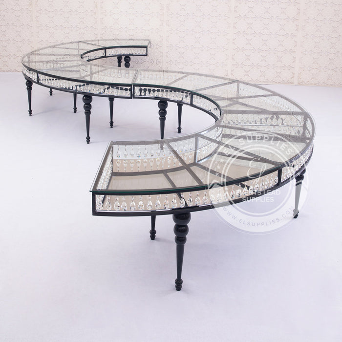 Serpentine black dining table with glass top